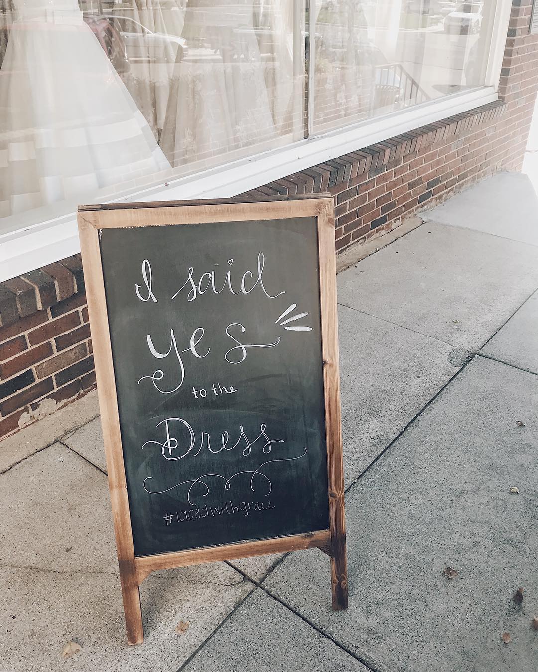 Outside sign that reads "I said yes to the dress" outside of Laced With Grace Bridal Boutique