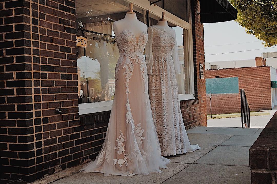 Two mannequins dressed in different styles of wedding dresses